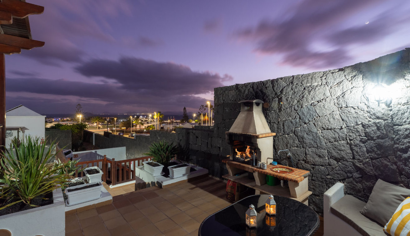 Outdoor dining at the barbecue and views across Playa Blanca Lanzarote at night